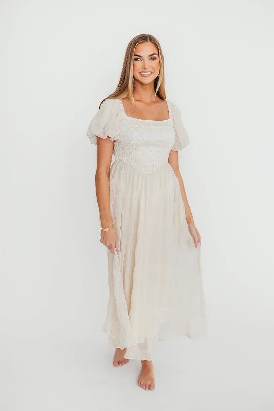 Midi dresses with ruffled bodices for a more pronounced feminine look Laura Puff Sleeve Smocked Midi Dress in Ecru Midi dresses with ruffled bodices for a more pronounced feminine look Laura Puff Sleeve Smocked Midi Dress in Ecru