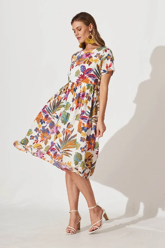 Midi dresses with side slits for a sexy and elegant appearanceSonya Smock Midi Dress In White With Bright Multi Floral Midi dresses with side slits for a sexy and elegant appearanceSonya Smock Midi Dress In White With Bright Multi Floral