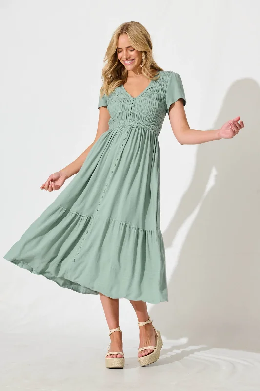Midi dresses with fringe details for a fun and energetic styleZenith Midi Dress in Sage Green Linen Bend Midi dresses with fringe details for a fun and energetic styleZenith Midi Dress in Sage Green Linen Bend